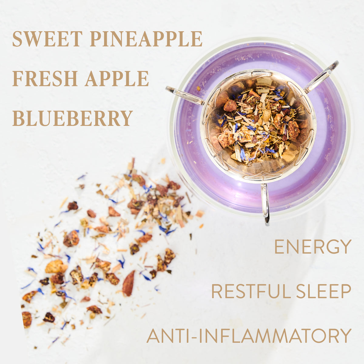 A top-down view of the Aquamarine Dream Herbal Adrenal Tea Refill Pouch- ARCHIVE blender, filled with fruits, herbs, and adaptogens, is surrounded by scattered ingredients. The image features text reading "Sweet Pineapple Fresh Apple Blueberry" and "Energy Calming Sleep Anti-Inflammatory." The blender rests on a sleek aquamarine surface.