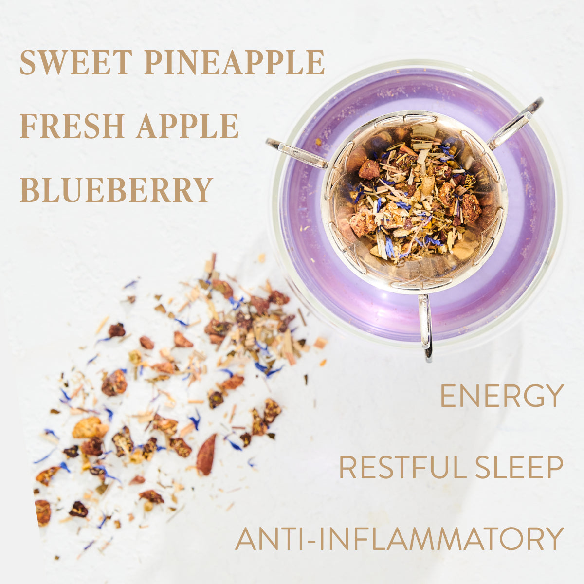 A top-down view of a tea blend in a purple-rimmed infuser, with scattered dried ingredients including pieces of pineapple, apple, and blueberries. Text labels read: &quot;Magic Hour Aquamarine Dream - Soothing Herbal Ayurvedic Adrenal Tonic, Sweet Pineapple, Fresh Apple, Blueberry, Energy, Restful Sleep, Anti-Inflammatory.