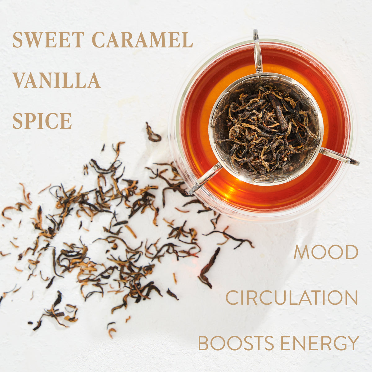 A glass cup of Magic Hour Aquarius: Visionary Goddess Tea with loose tea leaves in a tea infuser. Some tea leaves are scattered on a white surface. The text on the image reads: "Sweet Caramel, Vanilla, Spice" and "Mood, Circulation, Boosts Energy." Enjoy the organic essence in every sip of this loose leaf tea.