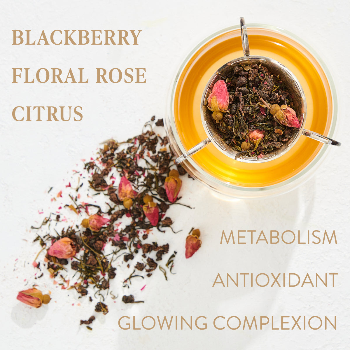 A glass cup filled with tea has a metal infuser containing Magic Hour's Aries - Garden of Eden Oolong loose leaf tea and rose buds. Dried tea leaves and rose petals are scattered beside the cup. Text reads: "BLACKBERRY, FLORAL, ROSE, CITRUS, METABOLISM, ANTIOXIDANT, GLOWING COMPLEXION.