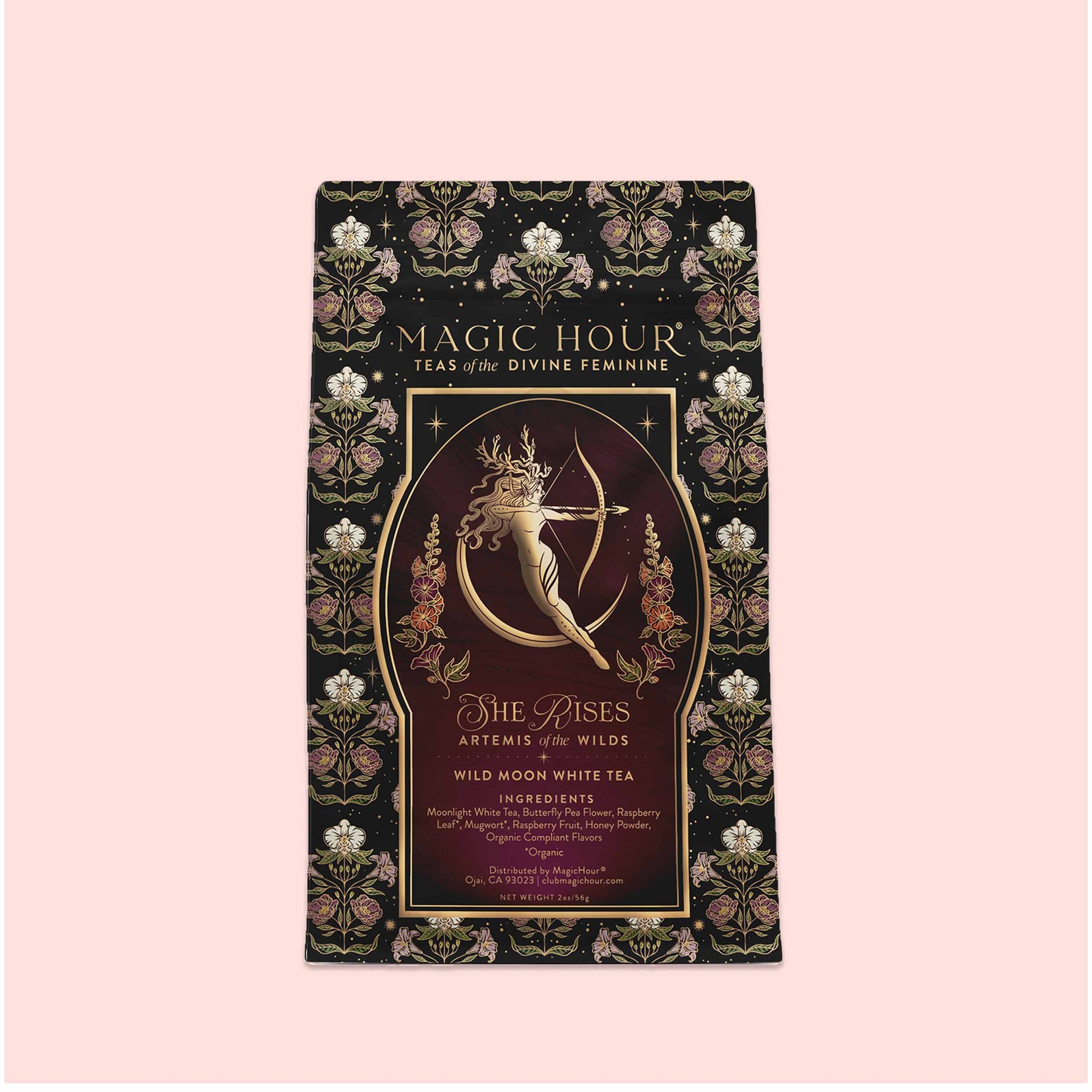 Presented in a decorative package labeled "Artemis of the Wilds: Wild Moon White Tea," this enchanting low-caffeine tea features a golden archer and floral designs set against a black background with pink accents. Savor the smooth, delicate flavors of moon white tea in every magical cup.