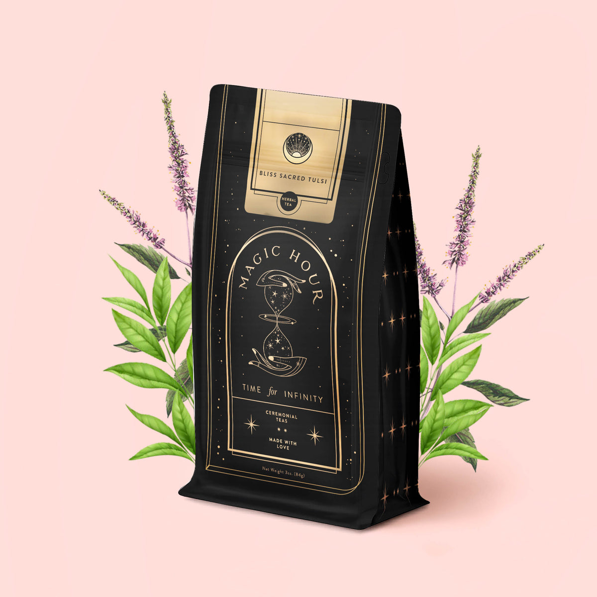 A package of Bliss: Sacred Tulsi Adaptogen Tea, adorned with gold accents and the “Magic Hour” label, stands before illustrated green leaves and purple flowers on a pale pink background, evoking the calming benefits of Tulsi (Holy Basil), celebrated for its natural sleep aid qualities.