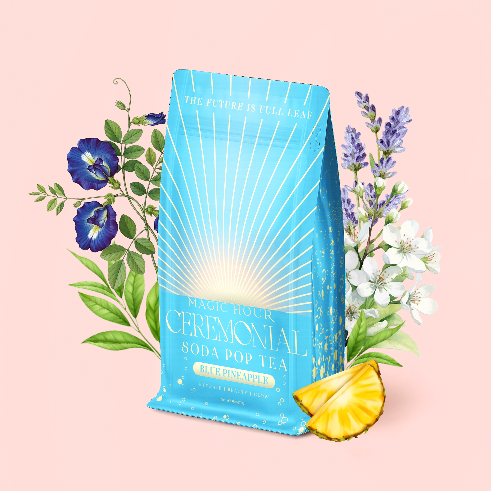 A blue bag of Blue Pineapple: Ceremonial Soda Pop Tea, labeled "Blue Pineapple," sits on a pale pink background surrounded by flowers and a pineapple wedge. This caffeine-free herbal blend features vibrant Blue Spirulina and Butterfly Pea Flower, and the bag is printed with the message, "The Future is Full Leaf.