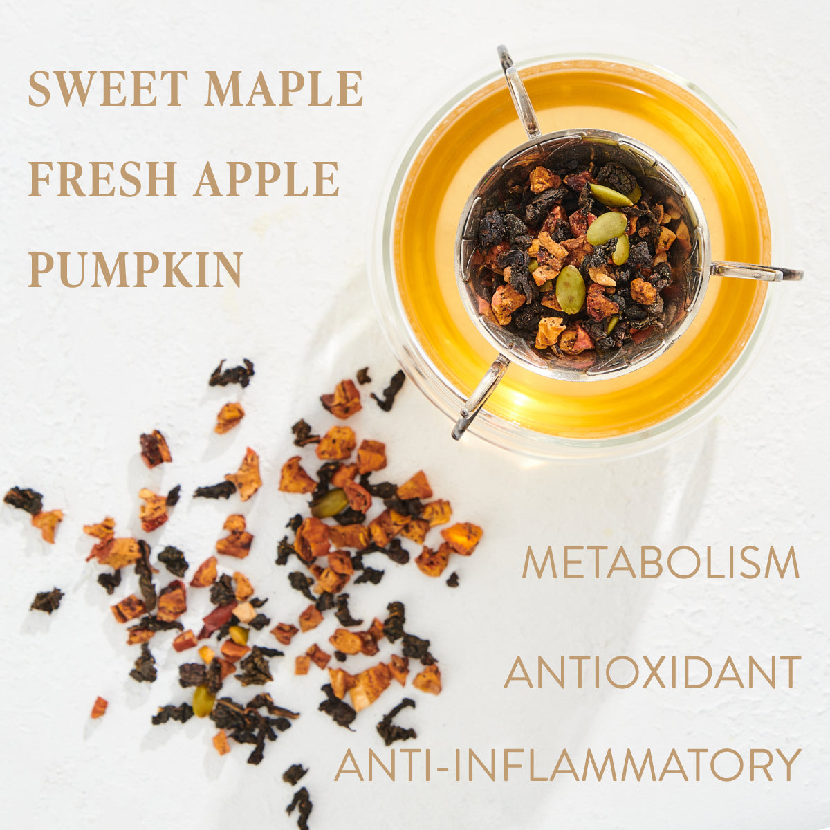 A cup of tea with a blend of sweet maple, fresh apple, and pumpkin pieces. The organic loose leaf tea is shown steeping with some scattered beside it. Words stating "METABOLISM," "ANTIOXIDANT," and "ANTI-INFLAMMATORY" are displayed. Discover the Magic Hour Capricorn: Maple Oolong Tea experience today.