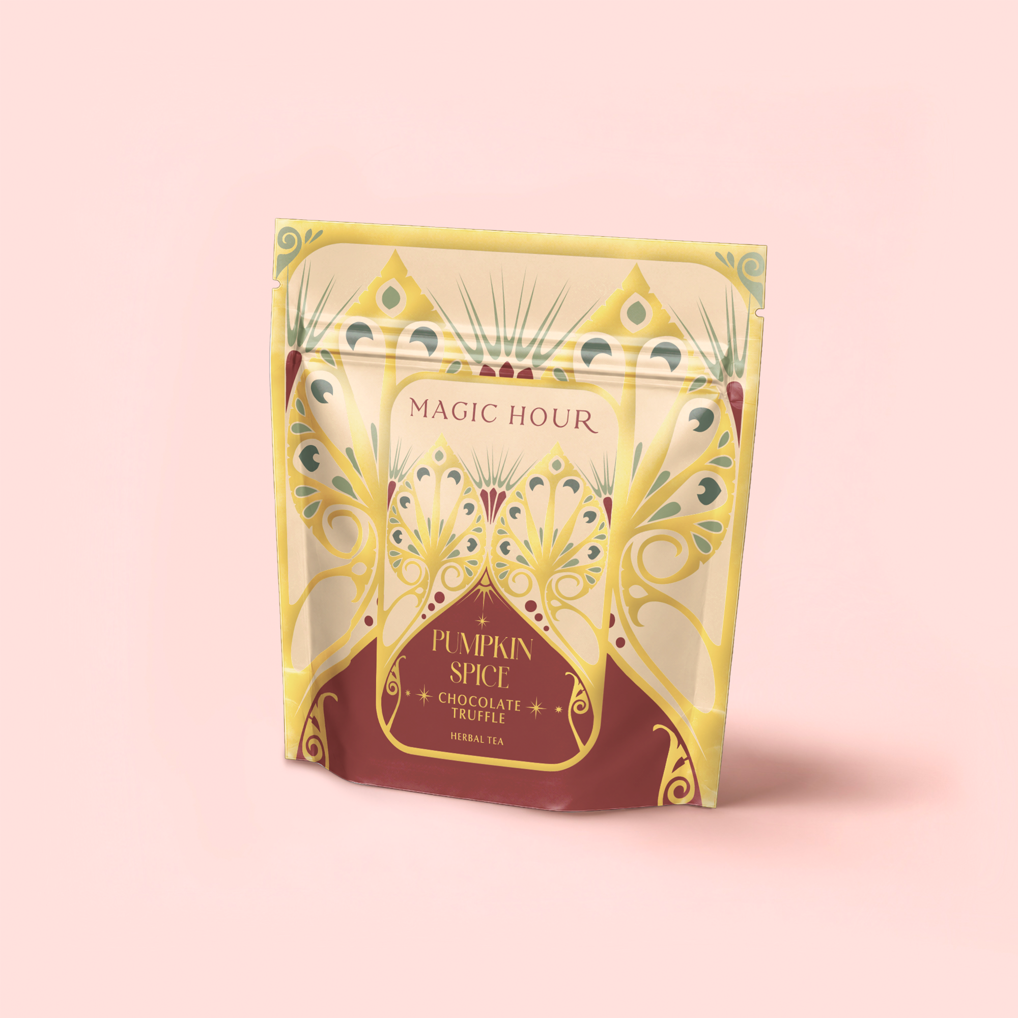 The "Pumpkin Spice Chocolate Truffle" herbal tea comes in a decorative yellow and maroon resealable pouch labeled "Magic Hour," featuring stylized patterns on a pale pink background. This caffeine-free blend offers an elegant, intricate design.