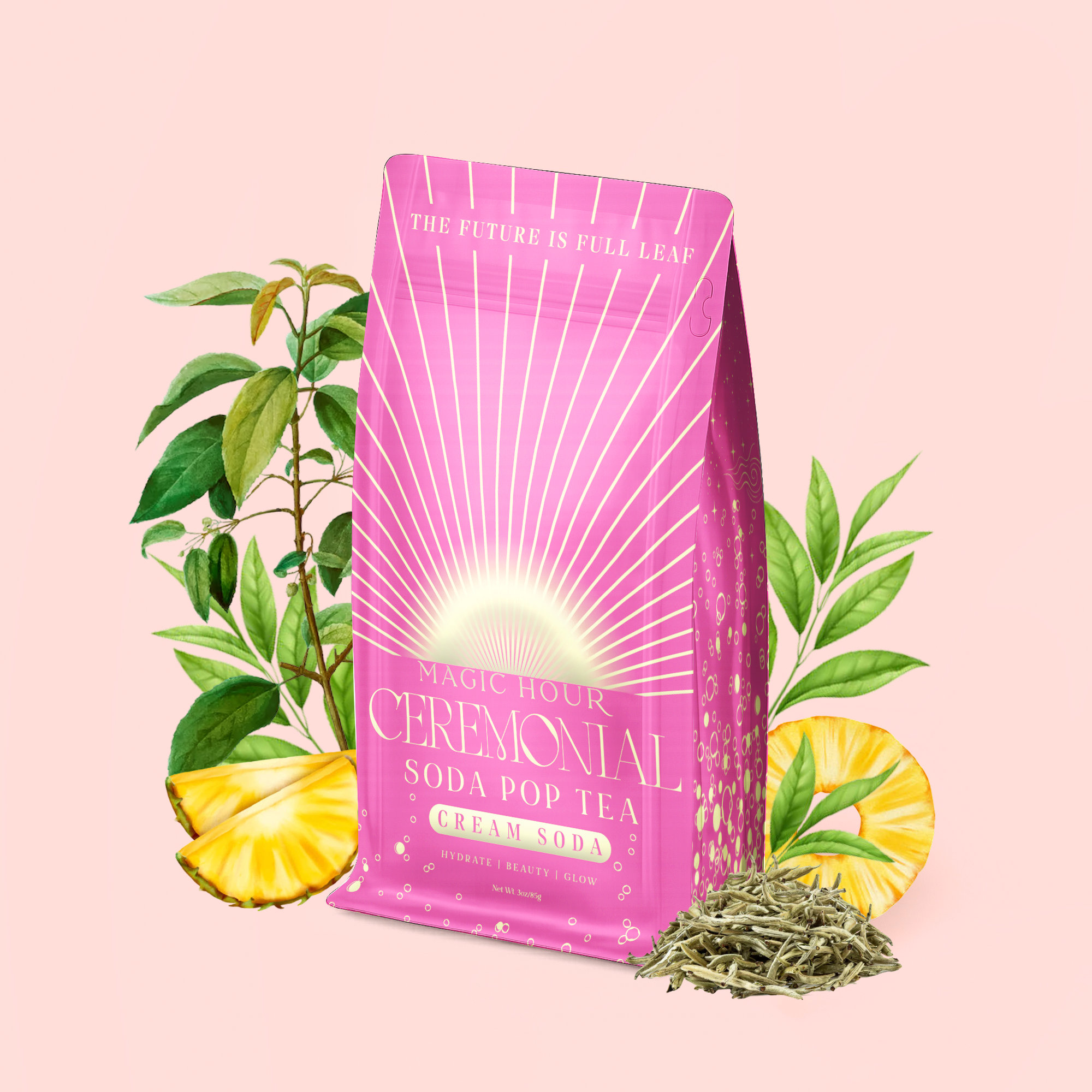 A pink bag labeled "Cream Soda White Tea: Ceremonial Soda Tea" rests amid green leaves, pineapple slices, and loose tea leaves on a pale pink background, evoking the refreshing taste of a sugar-free cream soda white tea blend.