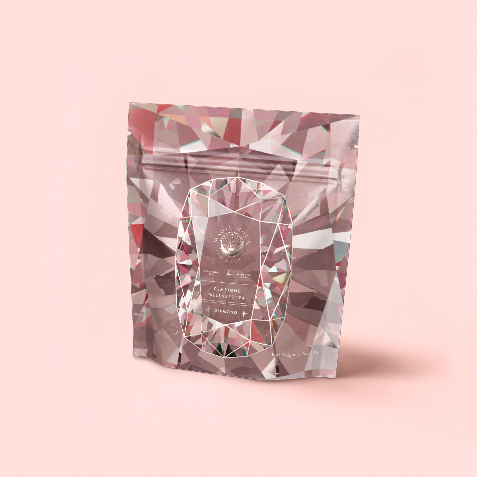 A stand-up pouch with a geometric diamond pattern on light pink, featuring the label “Diamond - Champagne & Strawberry Jasmine White Tea for Beautiful Skin” in white text within a central oval frame.