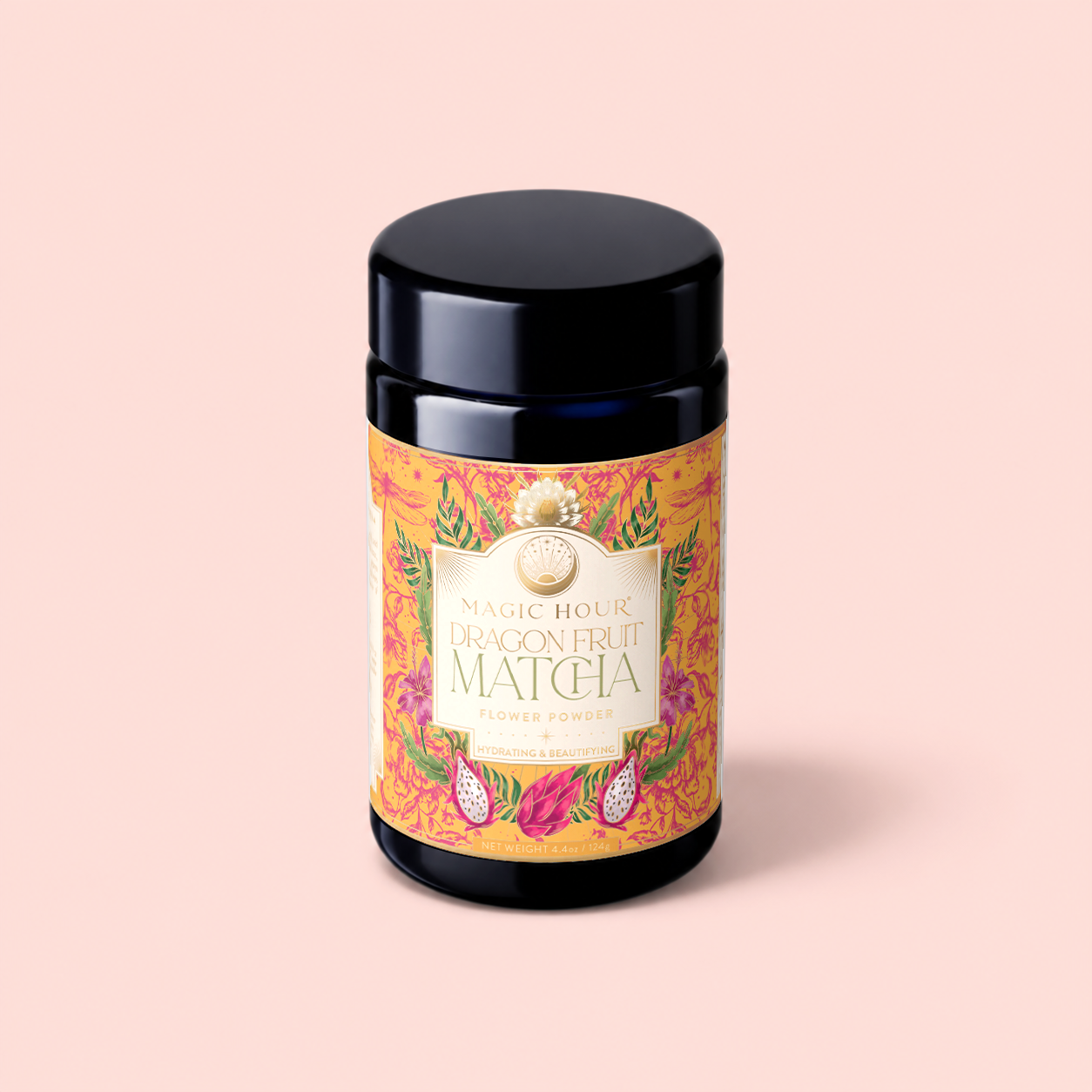 A black jar labeled "Flower Powder: Dragon Fruit Matcha" rests on a pale pink background. The label is adorned with vibrant dragon fruit illustrations and decorative patterns, emphasizing the ceremonial matcha blend crafted to support gut microbiome health.