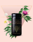 A black jar labeled "Earth Grounding & Manifestation Magic Hour" sits among green leaves and flowers with a gold triangle on a blush pink background—an ideal feature for any Monthly Tea Subscription Box lover.