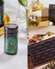 A collage of three images: a tea container with geometric green designs, a gold tea infuser near a box labeled "Emerald May Birthstone Mini Gift Set," and a flat-lay of a dark blue "Magic Hour" box with gold stars, surrounded by herbs.