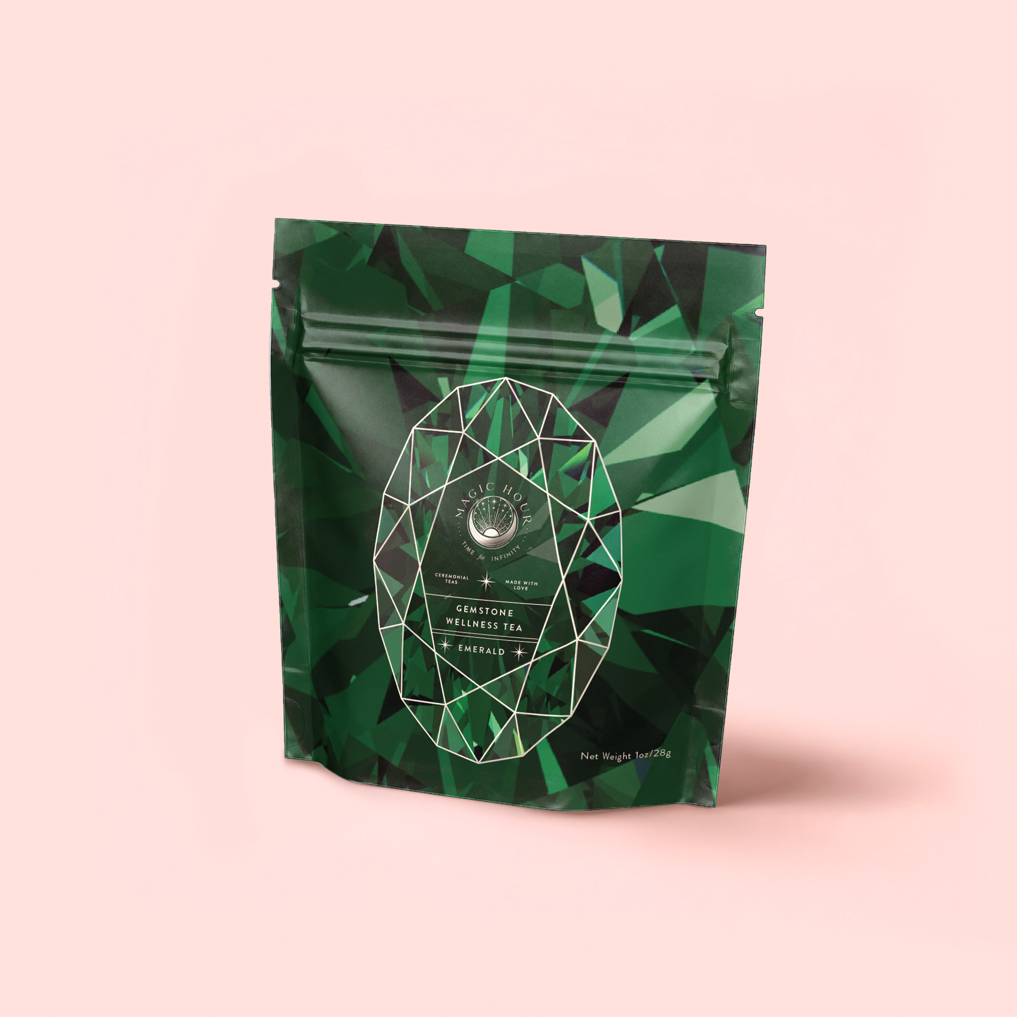 Resealable packaging for "Emerald - Cherry Blossom Pineapple Cream Green Tea" features a gemstone pattern, emerald-cut design, and circular logo on a light pink background, inspired by Japanese green tea.