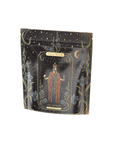 A black packaging bag showcasing a tarot card design labeled "The Emperor," featuring a robed, crowned figure with outstretched hands, encircled by an elaborate celestial-themed border adorned with stars, moons, and floral elements. Ideal for inclusion in your Monthly Magic First Sips Tea Subscription Box from Magic Hour Medicinal Herbal Wellness Teas.