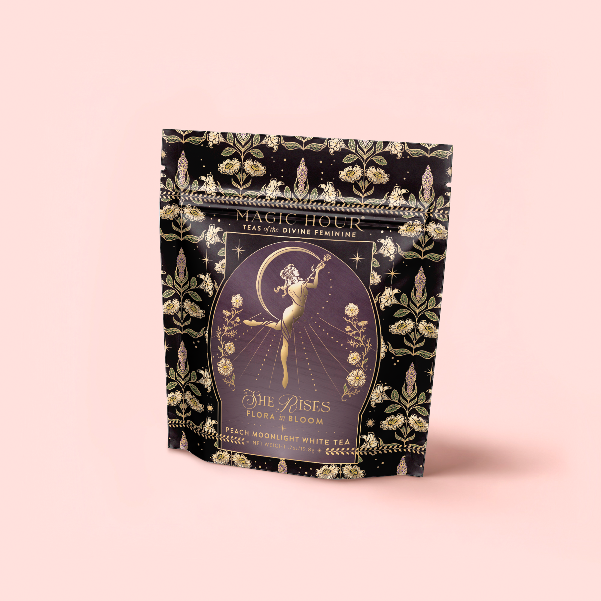 A decorative black and gold tea package labeled "Flora In Bloom: Peach Moonlight White Tea" by Magic Hour features an elegant, celestial feminine figure amid floral and star motifs on a light pink background.
