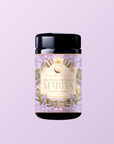 A jar of Flower Powder: Blueberry Lavender Matcha with a floral label, made from organic ceremonial matcha sourced from Kagoshima, displayed on a light purple background.