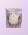 A lavender pouch labeled "Flower Powder: Blueberry Lavender Matcha" with botanical designs, features organic ceremonial matcha and is set against a light purple background.