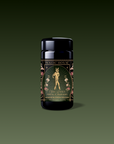 A black tea canister labeled "Magic Hour" features a gold and floral design with an illustrated woman holding flowers. The label reads "Freya: The Radiant Goddess Tea Radiant Jasmine Blossom Oolong" on a dark green gradient background.
