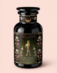 A black tea canister labeled “Magic Hour” features floral designs and an illustration of a woman. The tea, called “Freya The Radiant: Jasmine Bai Hao Oolong with Bergamot & Berry,” offers a fragrant blend inspired by the delicate notes of Oriental Beauty Oolong (Dong Fang Mei Ren).