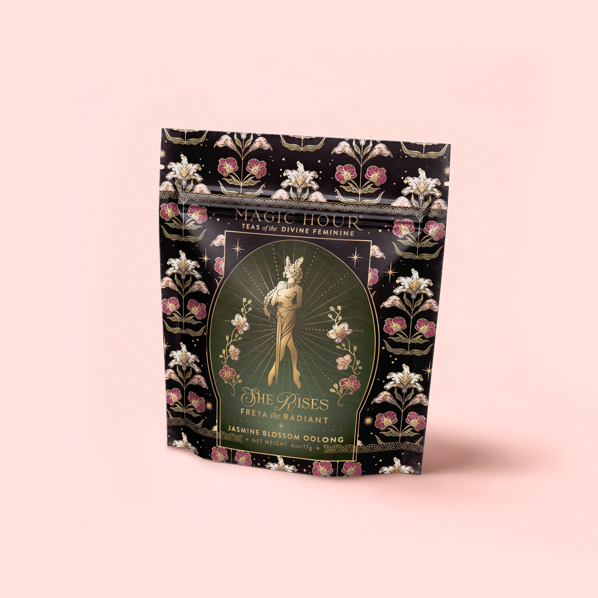A decorative black and gold tea package labeled "Freya The Radiant: Jasmine Bai Hao Oolong with Bergamot & Berry." The front displays an elegant female figure, floral patterns, and radiant details.