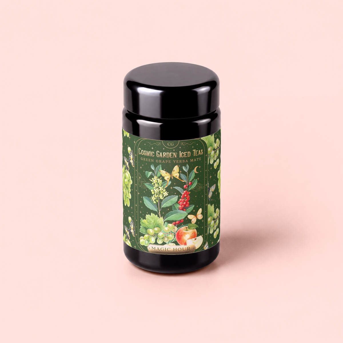 A black tea canister with a colorful floral label reading “Green Grape Yerba Mate: Cosmic Garden Iced Tea” sits on a light pink background. The decorative label is adorned with fruits, flowers, and leaves, suggesting vibrant ingredients like spirulina and green yerba mate woven into the design.