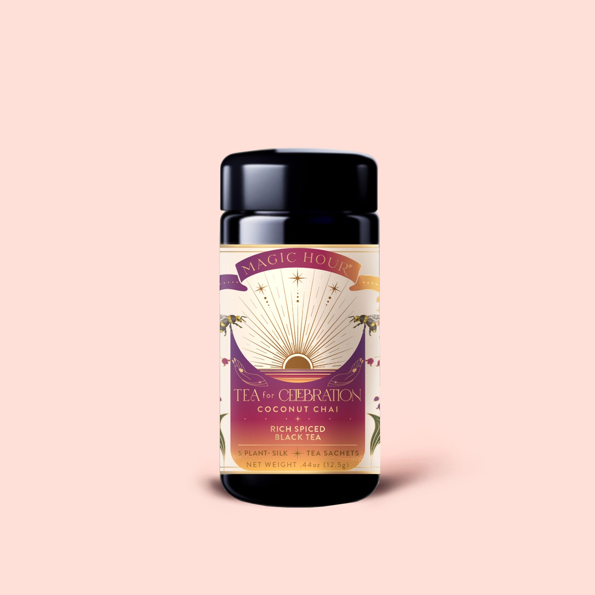 A jar of Magic Hour Tea for Celebration: Coconut Chai—Rich Spiced Black Tea Blend, adorned with a striking purple and gold label and set against a light pink background, infused with butterfly pea flower to add vibrant color and floral elegance.