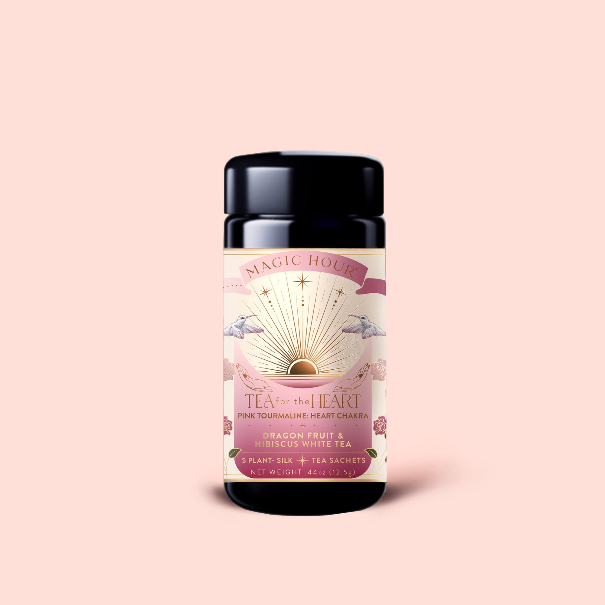 A jar of Tea for the Heart: Pink Tourmaline: Dragonfruit &amp; Hibiscus White Tea features pink, gold, and white label art adorned with sun, stars, and flowers; inside are exquisite dragonfruit and hibiscus white tea sachets blended with adaptogenic herbs.