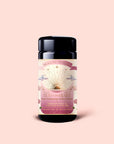 A jar of Tea for the Heart: Pink Tourmaline: Dragonfruit & Hibiscus White Tea features pink, gold, and white label art adorned with sun, stars, and flowers; inside are exquisite dragonfruit and hibiscus white tea sachets blended with adaptogenic herbs.
