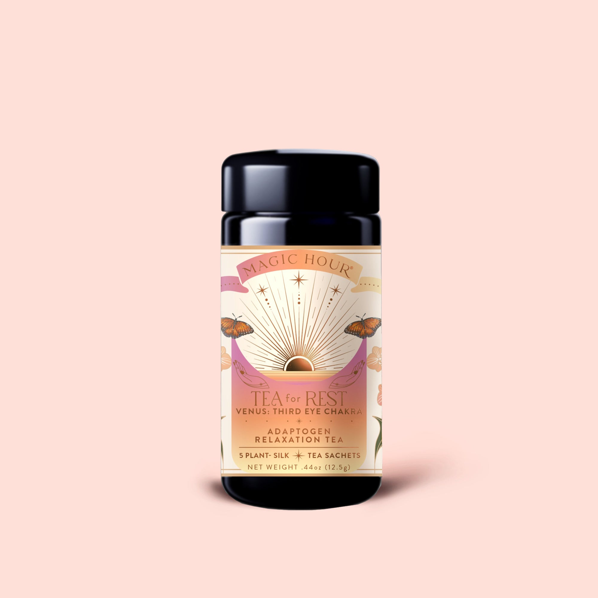A black tea canister labeled "Tea for Rest: Venus: Mango Blossom &amp; Nervines Herbal Tea" features a sun, butterflies, and floral design on a light pink background. The label highlights "Adaptogen Relaxation Tea" and "5 Plant Silk Tea Sachets." This soothing herbal blend includes organic chamomile to support relaxation and collagen production for a restful experience.
