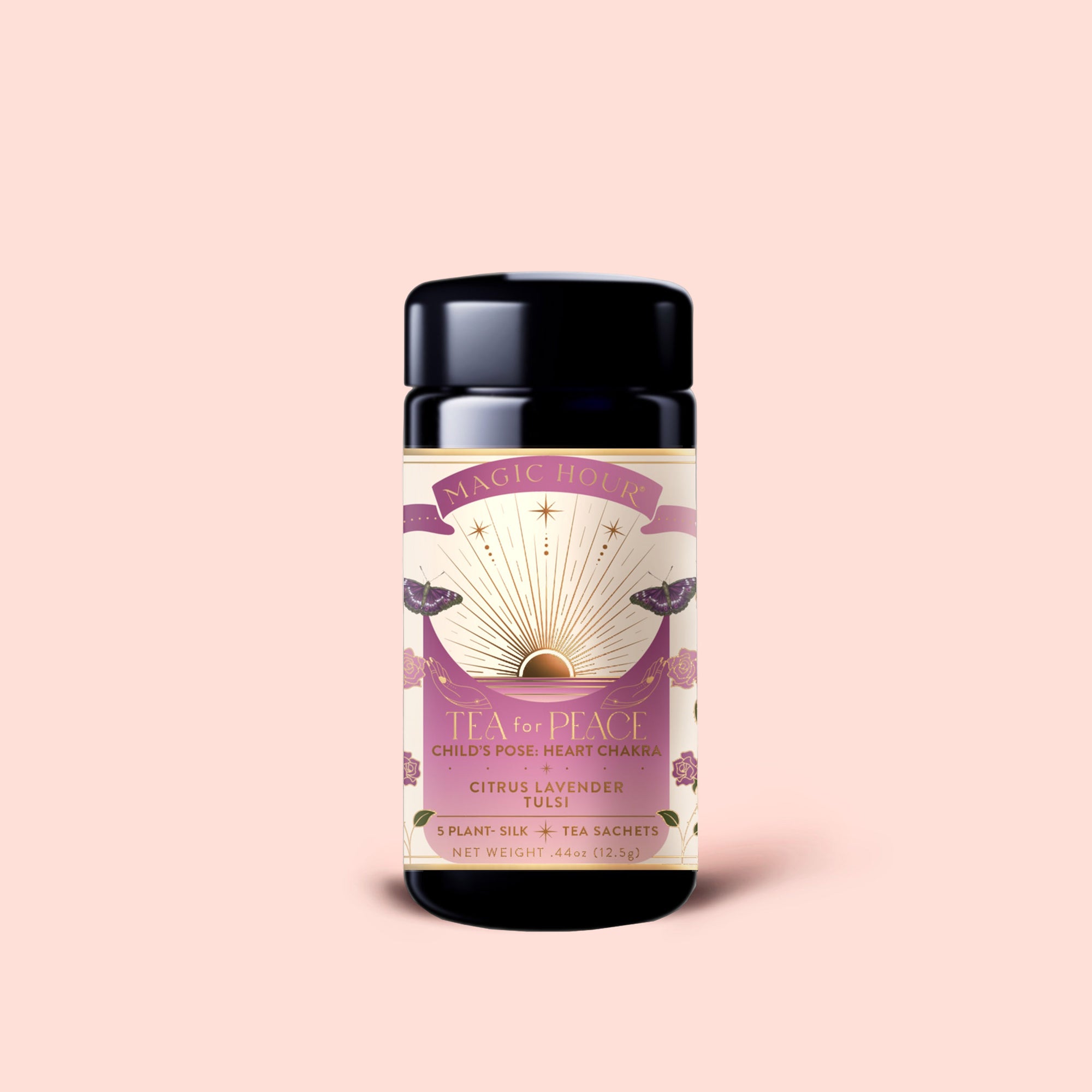 A black tea canister with a pink and gold label reading "Magic Hour Tea for Peace, Child's Pose, Heart Chakra, Citrus Lavender Tulsi" rests against a pale pink background. The Tea for Peace: Child's Pose: Citrus, Lavender &amp; Tulsi Herbal Tea Blend is an adaptogenic infusion thoughtfully crafted to relax your nervous system and invite serenity with every soothing cup.