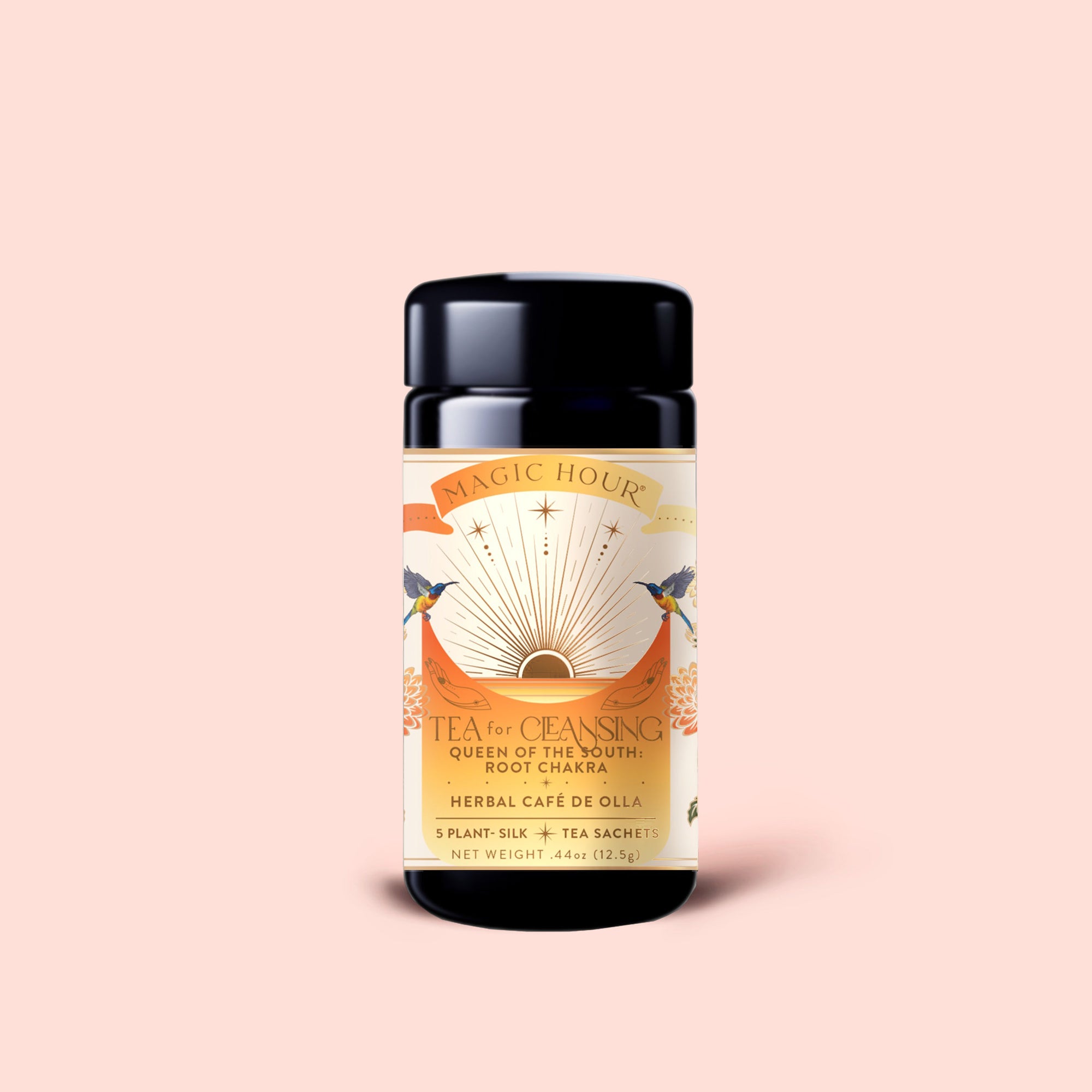 A cylindrical tin labeled "Tea for Cleansing: Queen of the South: Herbal Cafe de Olla," adorned with decorative sun, birds, and floral artwork, stands upright on a soft pink background. This antioxidant-rich, caffeine-free blend offers a nourishing herbal cafe de olla experience as enchanting as its presentation.