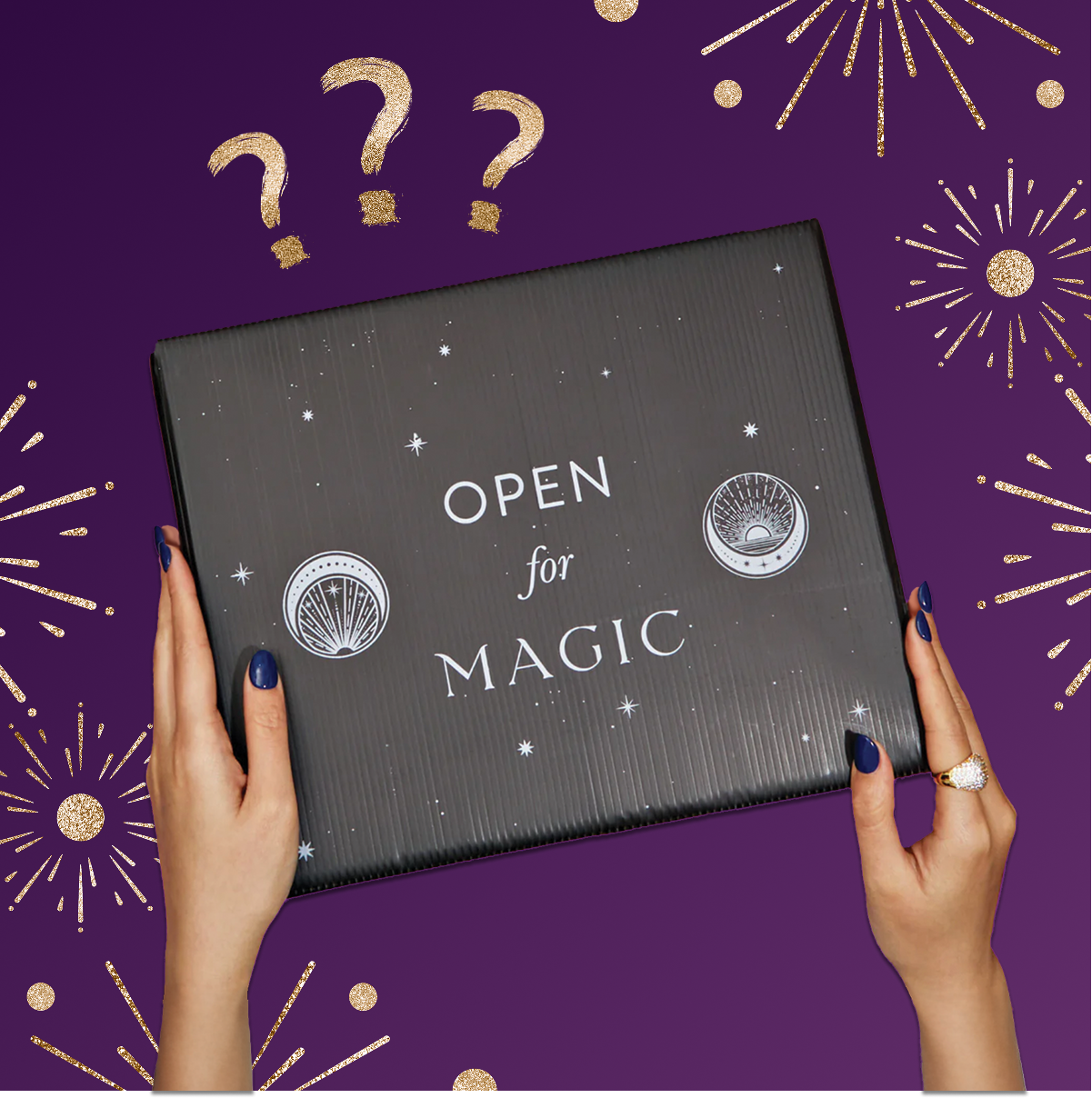 A person with dark blue nails holds the Black Friday Mystery Box, labeled "OPEN FOR MAGIC," against a purple background with gold stars, fireworks, and question marks—perfect for discovering premium teas and unique tea accessories.