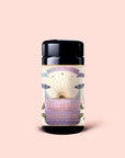 A black tea canister labeled "Tea for Healing: Aquamarine Dream" features sun and floral artwork on a light pink background. This adaptogen herbal tea blend combines blueberries, pineapple, and nervines to offer gentle nervous system support, with 12 tea sachets inside.