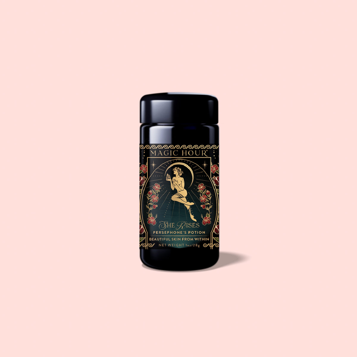 A black tea canister labeled “Magic Hour,” adorned with an illustration of a woman surrounded by floral designs, contains Persephone’s Potion: Pomegranate &amp; Jasmine Green Tea. Infused with delicate notes of jasmine green tea and pomegranate, it offers a truly enchanting experience. The background is light pink.