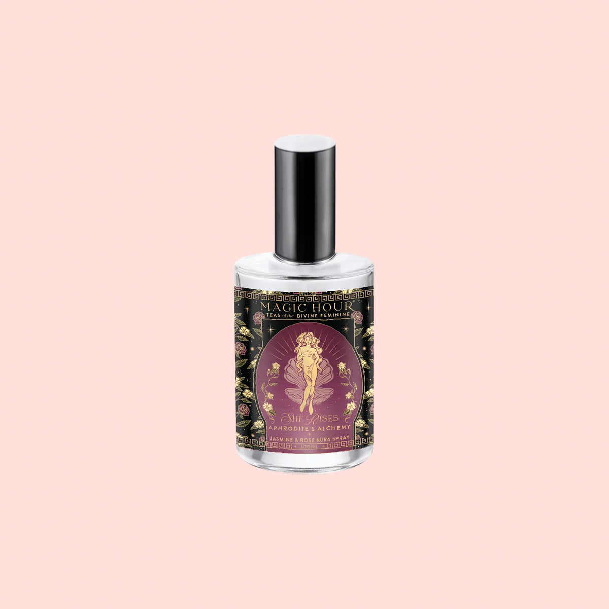 A clear spray bottle with a silver cap displays a decorative label featuring a golden fairy set against a purple background adorned with floral designs. The label reads “Aphrodite’s Alchemy - Jasmine & Rose Beauty Mist.” Ideal as a jasmine rose facial mist, this bottle is presented on a light pink background.