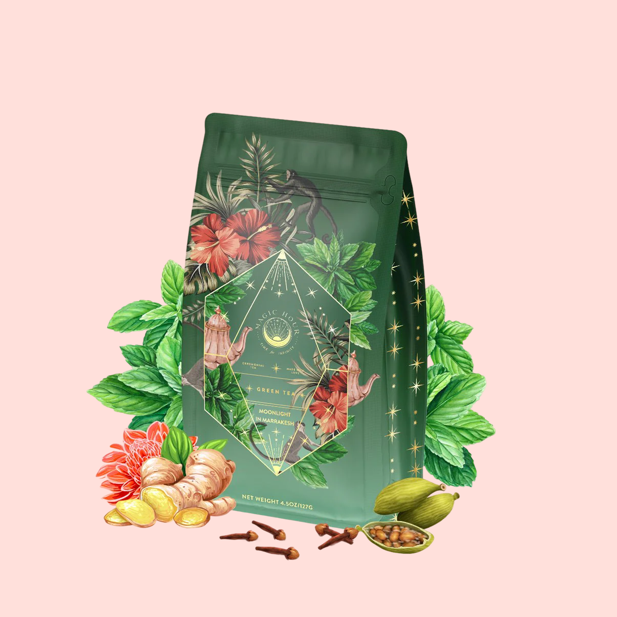 Moonlight in Marrakesh: Spiced Mint Green Tea packaging features floral and botanical designs, surrounded by illustrated leaves, hibiscus, ginger, pomelo, cardamom, and cloves on a light pink background.