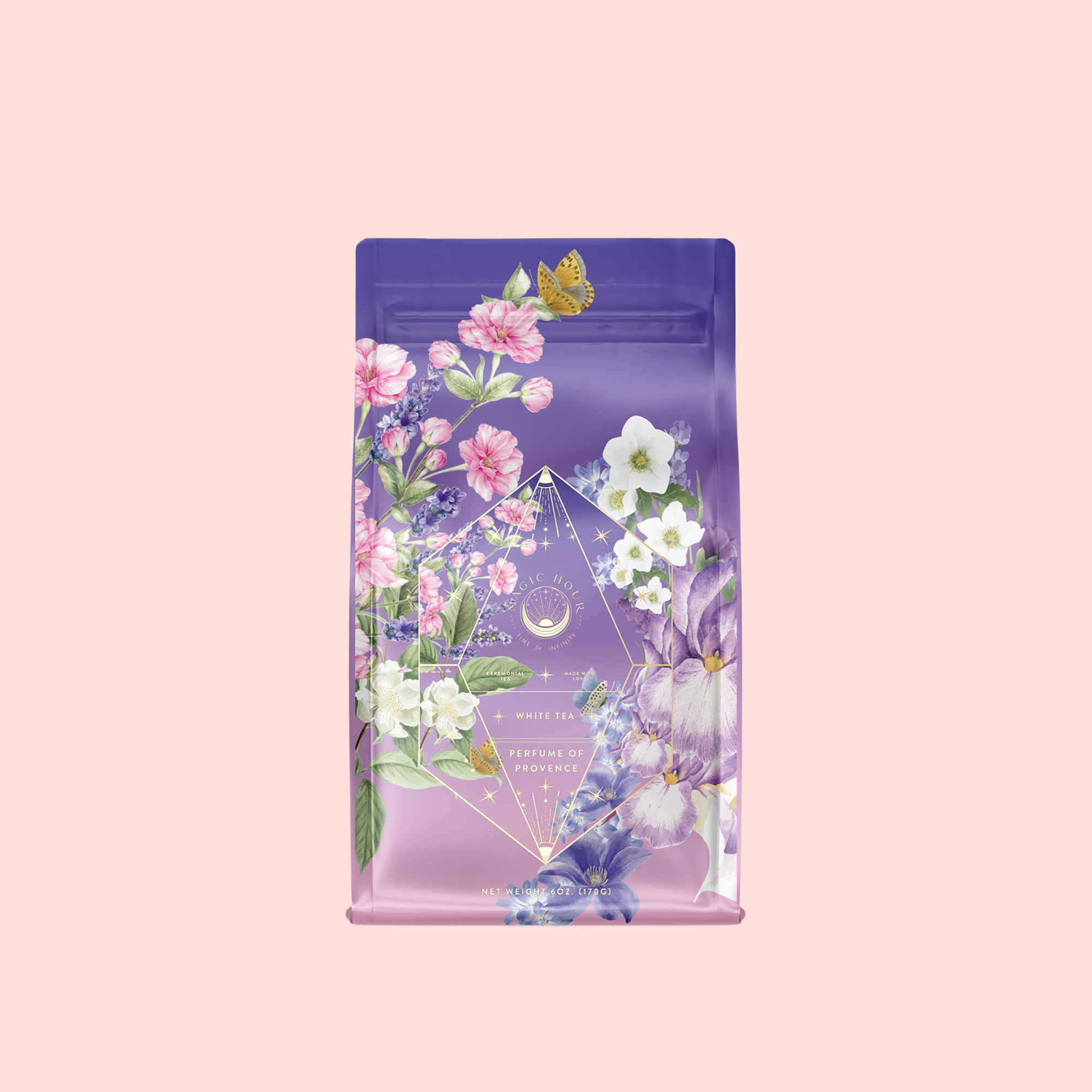 A purple and pink tea package with colorful floral art and a yellow butterfly sits on a light pink background. The label reads "Perfumes of Provence: Lavender Bouquet Tea for Calm Moods and Beautiful Skin.