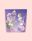 A purple tea pouch with floral art and a yellow butterfly, labeled “Perfumes of Provence: Lavender Bouquet Tea for Calm Moods and Beautiful Skin”—ideal for fans of Provence flower teas.