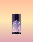 The Perfumes of Provence: Lavender Bouquet Tea for Calm Moods and Beautiful Skin deodorant stick, with a floral geometric label, stands against a soft peach-yellow gradient background, evoking Provence flower tea.