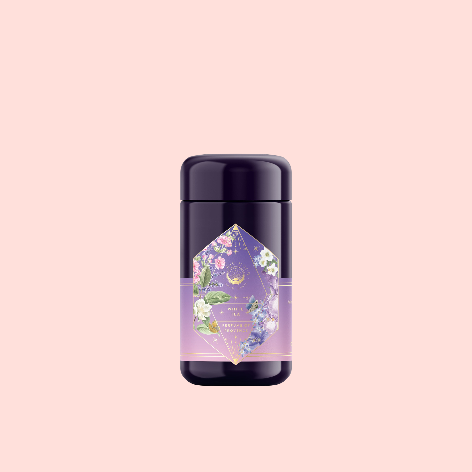 A purple cylindrical container labeled “Perfumes of Provence: Lavender Bouquet Tea for Calm Moods and Beautiful Skin” features pastel florals and geometric designs, standing out against a light pink background.