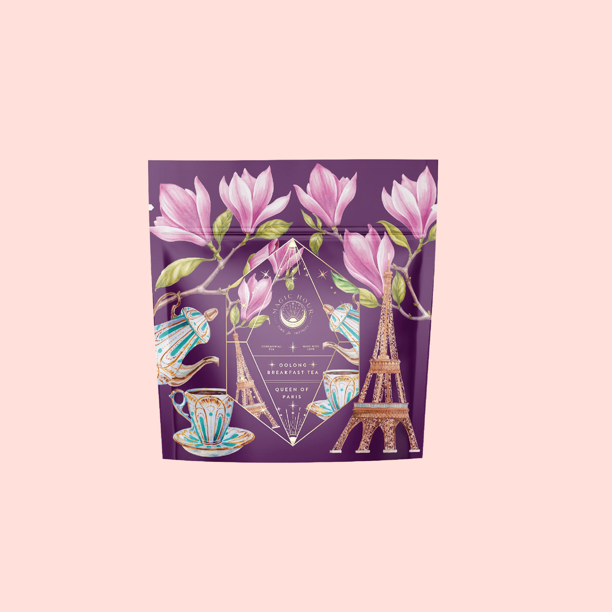 A purple package decorated with magnolia flowers, a tea set, and the Eiffel Tower highlights Breakfast in Paris-Oolong Black Tea Scented with Fruits & Flowers of Secret Parisian Gardens against a light pink background.