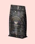 A decorative tea bag labeled "Goddess of Earl: Lavender London Fog – Tea for Blooming Clarity & Calm Moods," with botanical and celestial designs on pink, perfect for a soothing cup of Lavender Earl Grey.