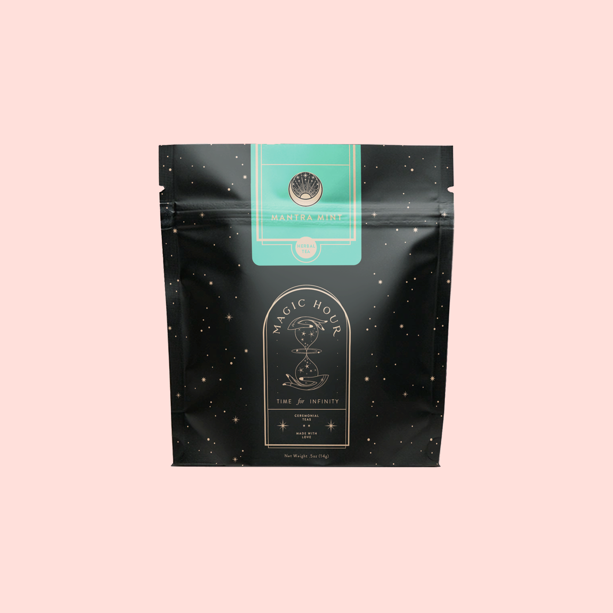 A black resealable pouch with gold stars and a green label displays “Mantra Mint™ Herbal Tea.” Below, a circular emblem reads “Magic Hour: Time ∞ Infinity.” The caffeine-free tea sits against a light pastel pink backdrop.