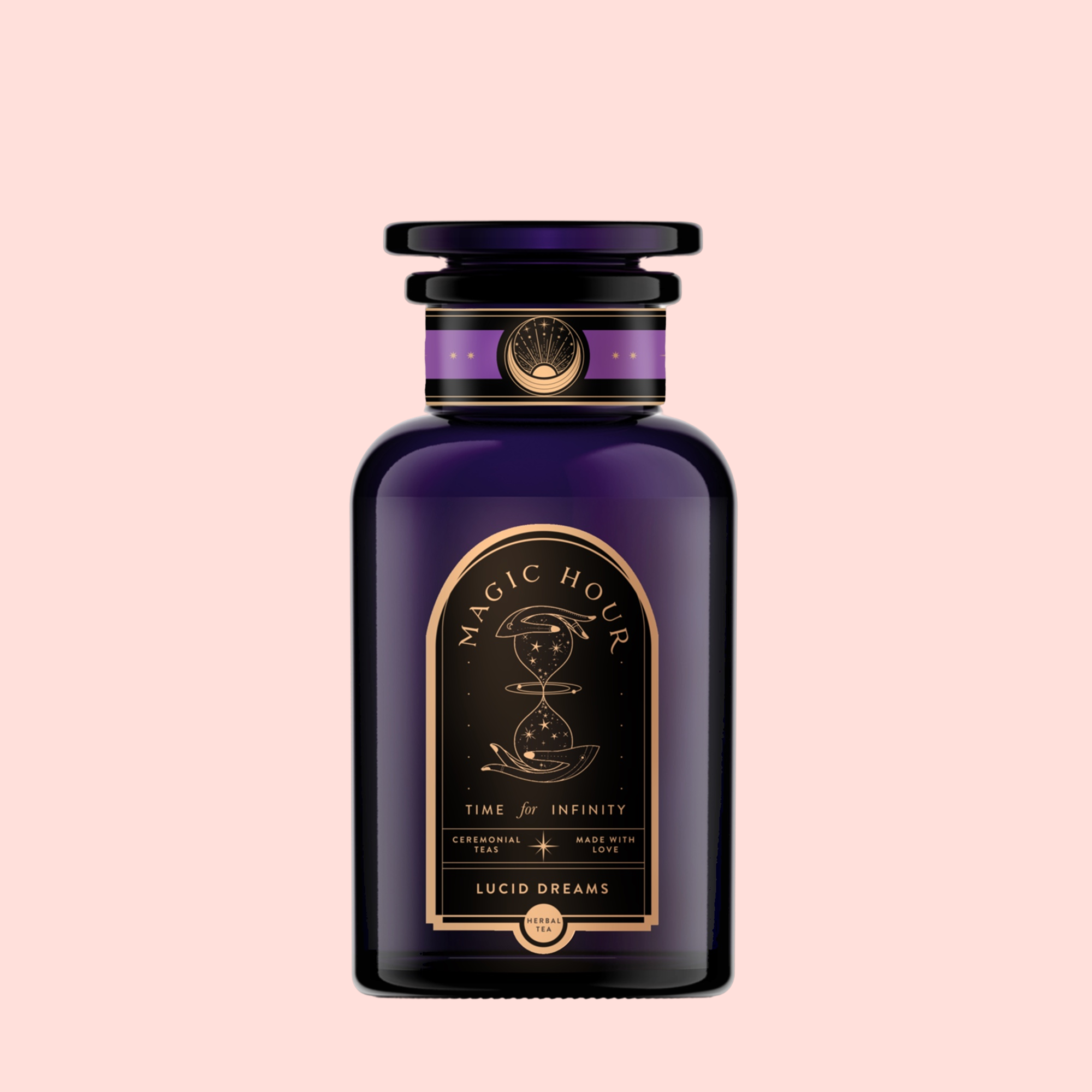 A dark violet "Magic Hour" glass jar with gold and black celestial art holds Lucid Dreams: Tulsi-Turmeric Herbal Tea for Sleep & Calm—a caffeine-free chai—set against a pale pink background.