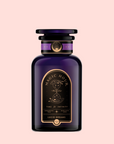 A dark violet "Magic Hour" glass jar with gold and black celestial art holds Lucid Dreams: Tulsi-Turmeric Herbal Tea for Sleep & Calm—a caffeine-free chai—set against a pale pink background.