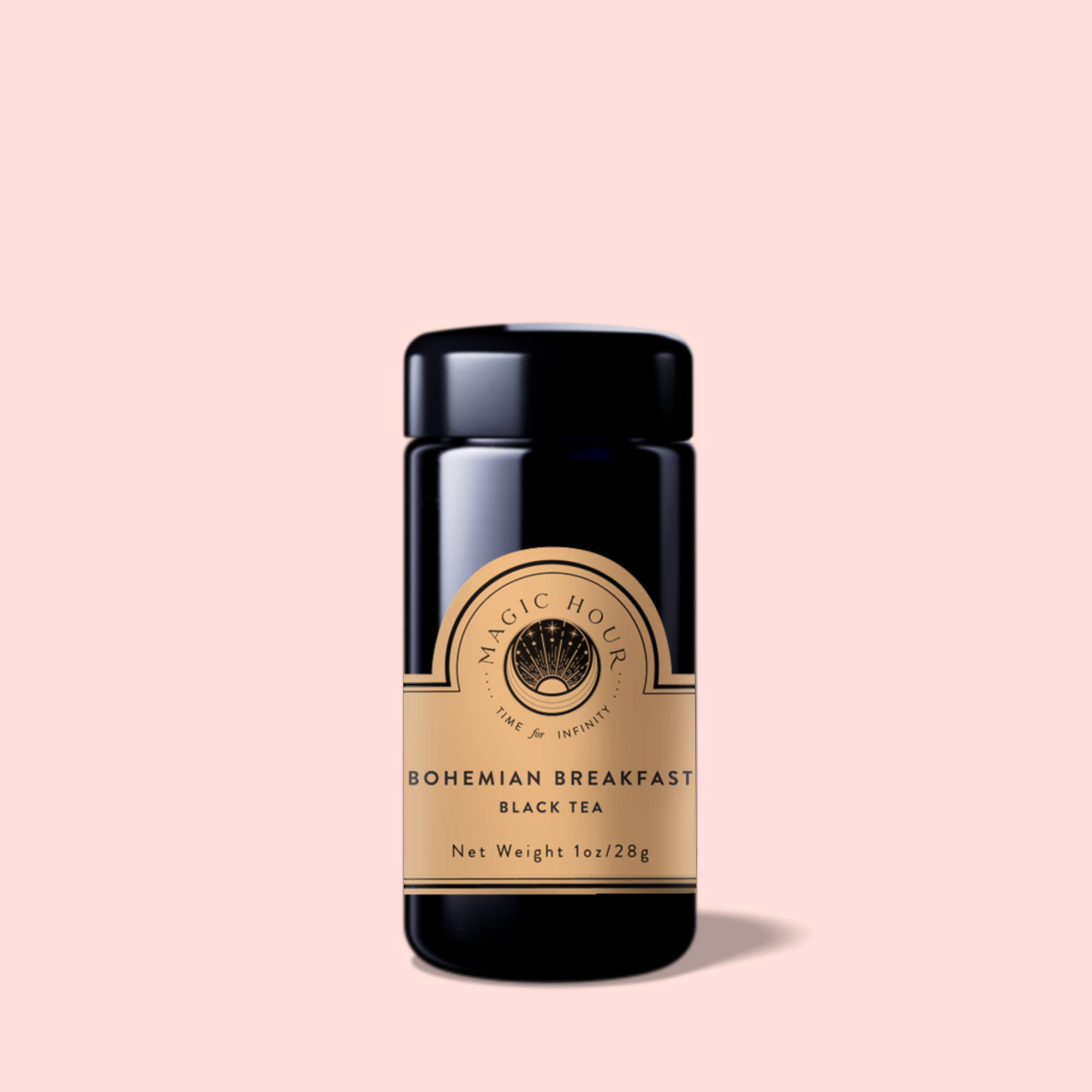 A black tea jar labeled "Bohemian Breakfast Vanilla Puerh Black Tea for Digestion &amp; Energy" with a gold label sits on a light pink background. The 1 oz (28g) jar is a perfect coffee alternative.