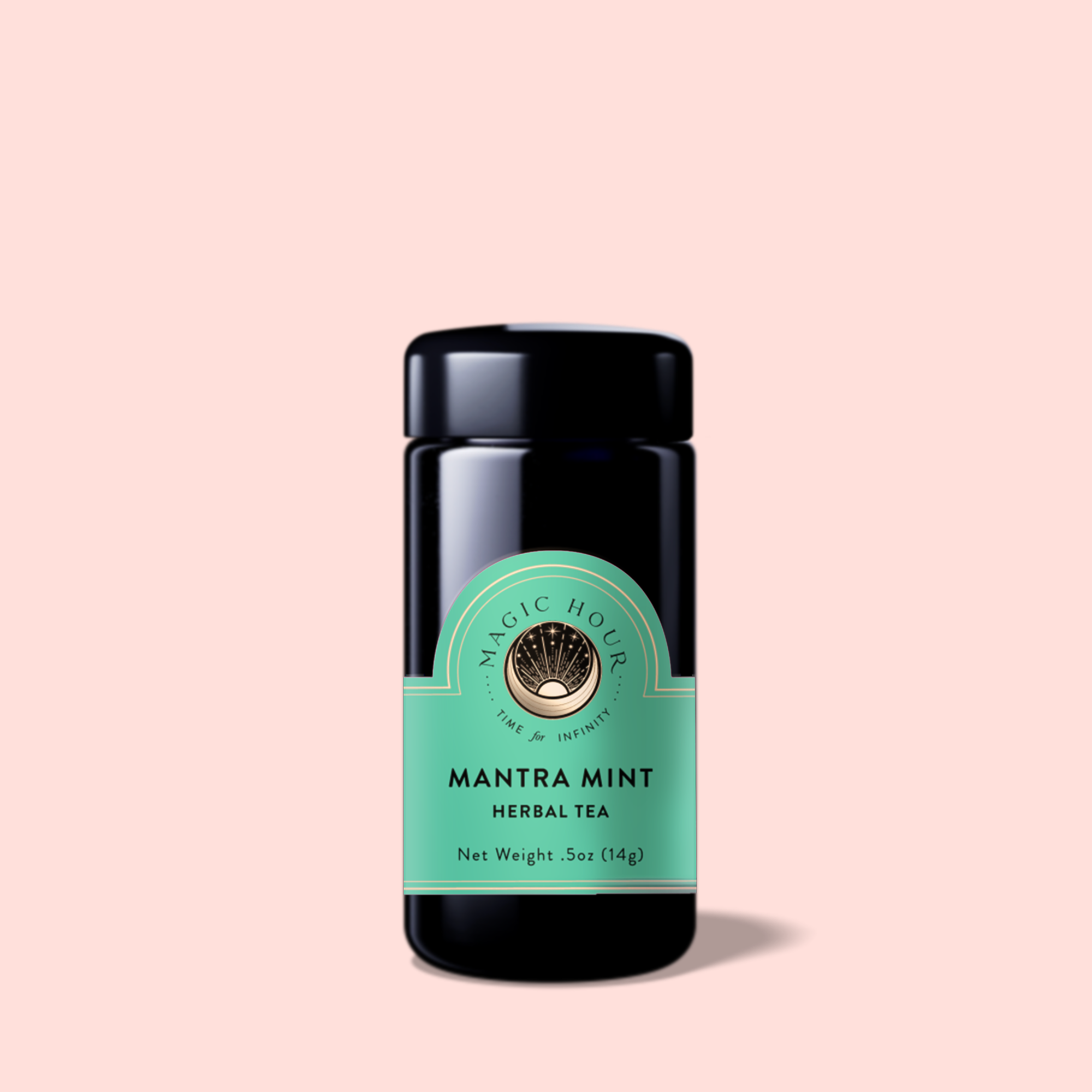 A black jar of Mantra Mint™ Herbal Tea, a caffeine-free blend with Ashwagandha and a green label with a circular logo, is centered on a light pink background.