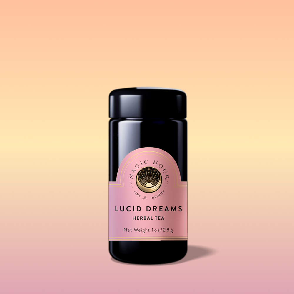 A black tea jar labeled "Lucid Dreams: Tulsi-Turmeric Herbal Tea for Sleep &amp; Calm" with a pink and gold label, set against a peach-to-soft-pink gradient. A caffeine-free blend, the jar casts a soft shadow.