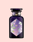 Perfumes of Provence: Lavender Bouquet Tea for Calm Moods and Beautiful Skin is in a dark purple bottle with a black cap, featuring a floral label with white, pink, and purple flowers, gold celestial accents, and a pale pink background.