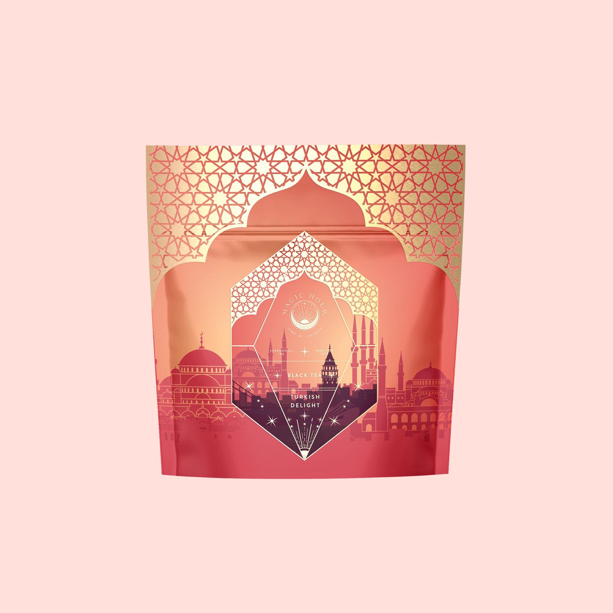 Turkish Delight, an aromatic caffeine-free herbal tea, comes in a decorative red and gold package with geometric patterns and a cityscape silhouette inspired by Istanbul architecture on a light pink background.