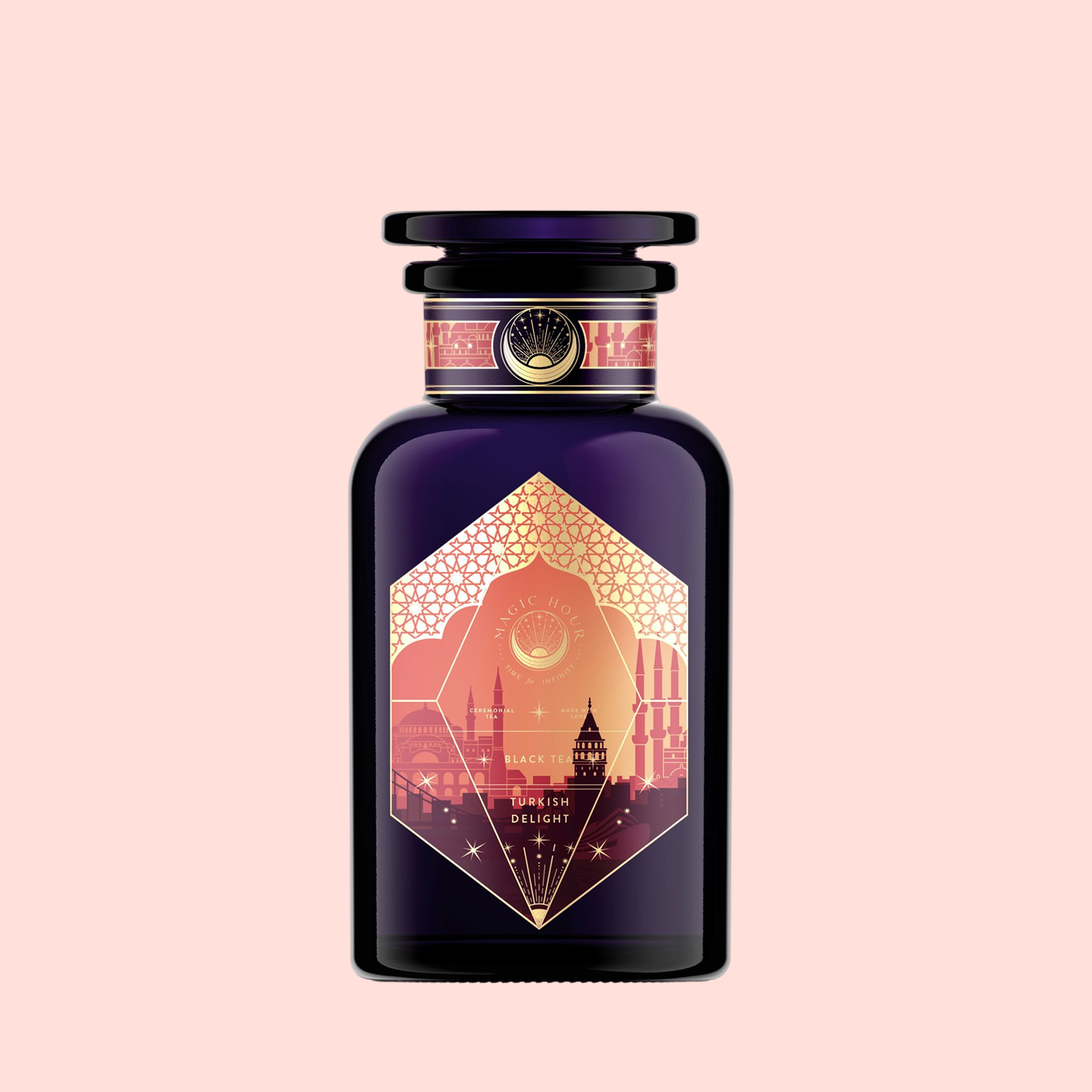 A dark purple "Turkish Delight" perfume bottle with a gold label showing domed Istanbul buildings, reading "Black Tea, Turkish Delight," evokes luxurious Turkish tea and sweets on a light pink background.