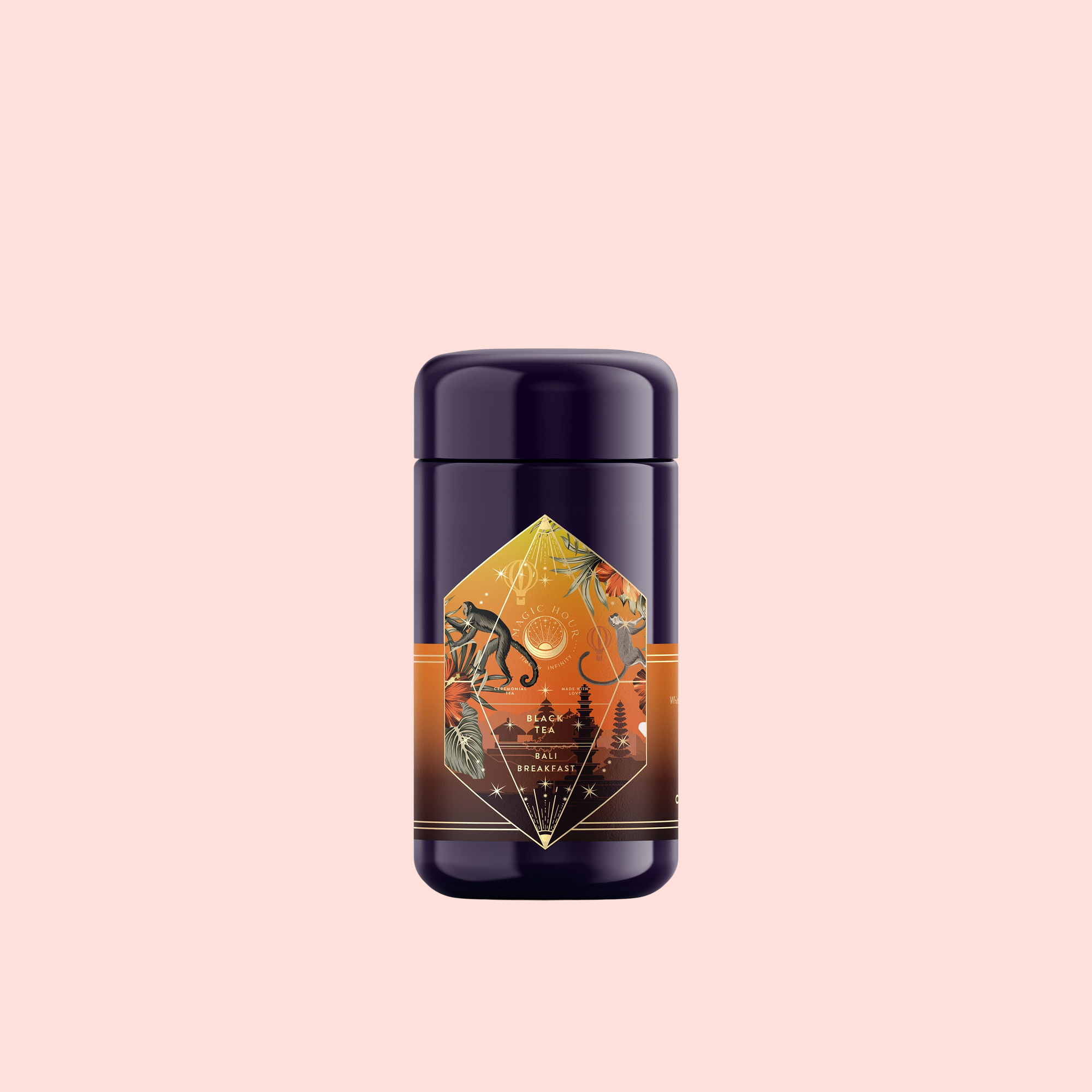 A dark purple cylindrical bottle with an amber and black geometric label showing botanical illustrations suggests Bali Bliss: Coconut-Lime &amp; Ginger-Melon White Tea, set against a plain light pink background.